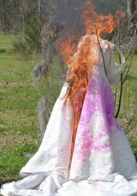 A woman burns her wedding dress to celebrate her divorce