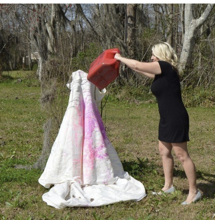 A woman burns her wedding dress to celebrate her divorce