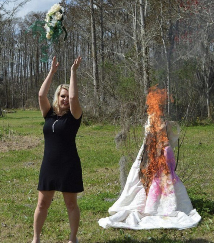 A woman burns her wedding dress to celebrate her divorce